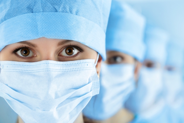Nurses wearing a mask and stand in single line
