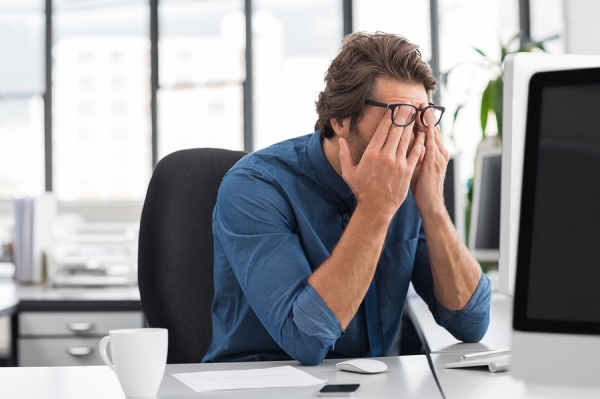 Tired man in the office's desk 